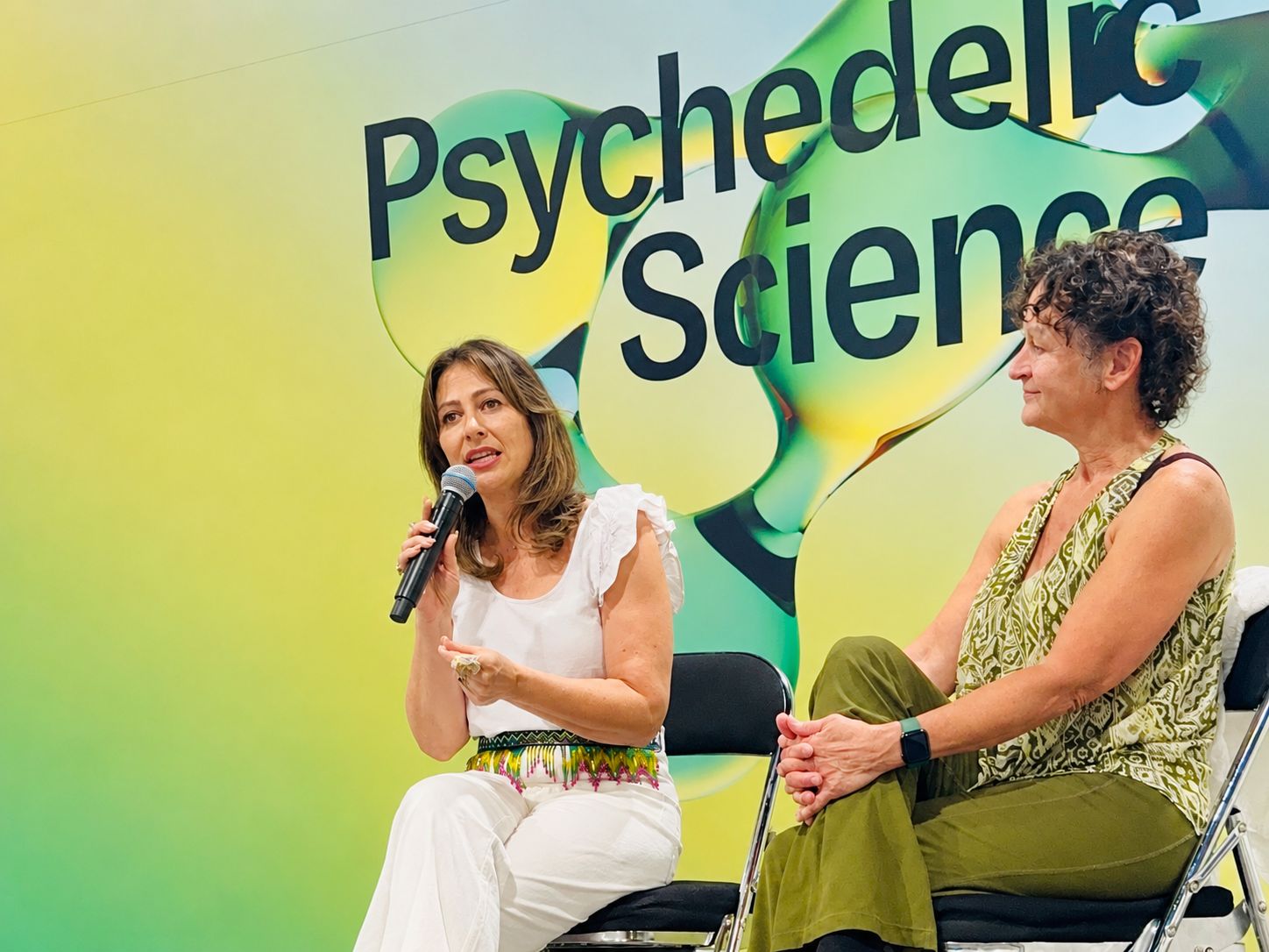 Linden Schaffer speaking on stage at Psychedelic Science